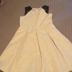 White dress with silver stitching.